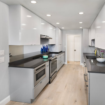 Contemporary High-Gloss Kitchen Remodel | Glass Display Cabinets & Modern Gray B