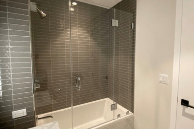 Photo of a modern bathroom with a hinged shower door.