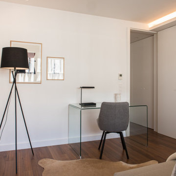 Home Office with Glass Desk, Gray Chair and Indirect Lighting