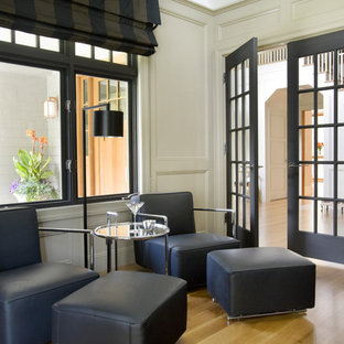 Design ideas for a medium sized modern study in Boston with beige walls, light hardwood flooring, no fireplace, a freestanding desk and beige floors.