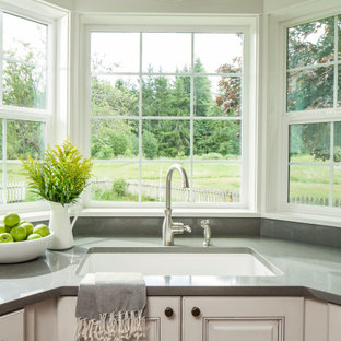Inspiration for a mid-sized country u-shaped open plan kitchen in Seattle with an undermount sink, raised-panel cabinets, white cabinets, quartz benchtops, white splashback, shiplap splashback, stainless steel appliances, medium hardwood floors, with island, brown floor and grey benchtop.