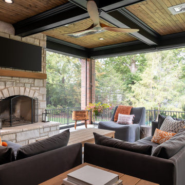 A stunning home exterior addition featuring coffered wood-slat ceilings, a cozy
