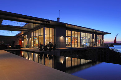 This is an example of a contemporary one-storey glass beige exterior in Austin.