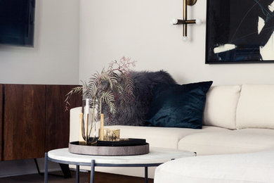 Example of a mid-sized minimalist open concept medium tone wood floor living room design in Los Angeles with gray walls, a standard fireplace, a concrete fireplace and a wall-mounted tv