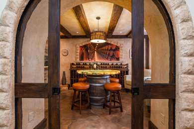 Inspiration for a mid-sized rustic concrete floor and multicolored floor wine cellar remodel in Minneapolis with storage racks