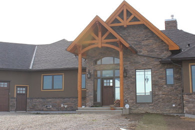 Example of a mountain style home design design in Calgary