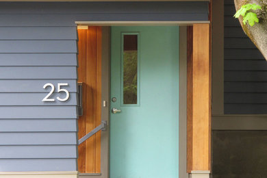 Photo of a contemporary entryway in Boston with a single front door and a blue front door.