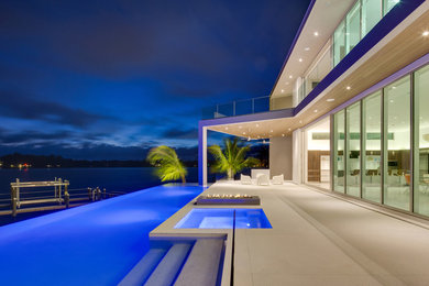 Deck - large modern backyard deck idea in Other with a fire pit and no cover
