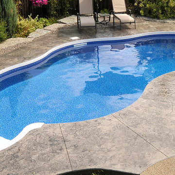 Fiberglass Pool w/ stamped concrete pool deck