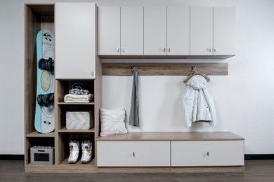 Example of a large minimalist gender-neutral dressing room design in Denver with flat-panel cabinets and white cabinets