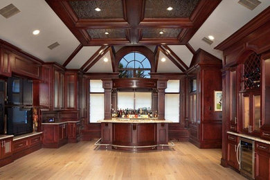 Inspiration for a large traditional home bar in New York.