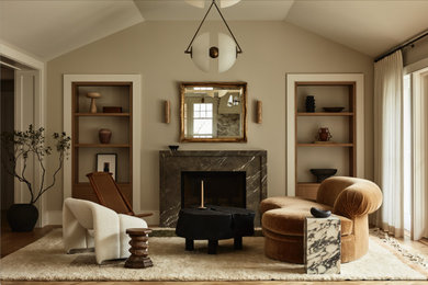 Example of a transitional medium tone wood floor, brown floor and vaulted ceiling living room design in San Francisco with beige walls, a standard fireplace and a stone fireplace