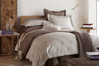 Example of a mid-sized urban master light wood floor bedroom design in Other with white walls
