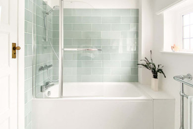 Inspiration for a mid-sized contemporary kids' blue tile and subway tile ceramic tile, gray floor and single-sink bathroom remodel in London with shaker cabinets, gray cabinets, a one-piece toilet, white walls, a drop-in sink, marble countertops, a hinged shower door, white countertops and a freestanding vanity