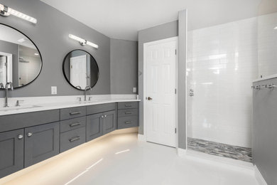 Mid-sized transitional master white tile and porcelain tile porcelain tile, white floor and double-sink bathroom photo in Orlando with recessed-panel cabinets, gray cabinets, a two-piece toilet, gray walls, an undermount sink, quartz countertops, white countertops and a floating vanity