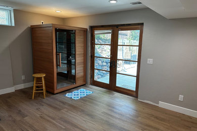 Inspiration for a mid-sized timeless walk-out laminate floor and brown floor basement remodel in Denver