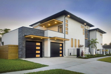Example of a mid-sized minimalist attached two-car garage design in Raleigh