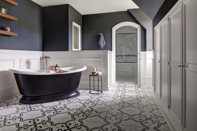 Inspiration for a large transitional master porcelain tile, multicolored floor, double-sink and wainscoting bathroom remodel in New York with a two-piece toilet, black walls, an undermount sink, quartz countertops, a hinged shower door and a freestanding vanity