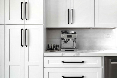 Inspiration for a mid-sized contemporary kitchen remodel in San Diego with a farmhouse sink, shaker cabinets, white backsplash, ceramic backsplash, stainless steel appliances and white countertops