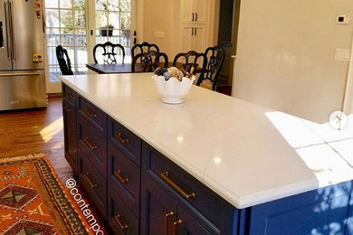 Inspiration for a transitional l-shaped eat-in kitchen remodel in New York with recessed-panel cabinets, blue cabinets, an island and white countertops