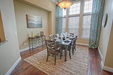 Mid-sized traditional separate dining room in Orlando with beige walls, dark hardwood floors and no fireplace.