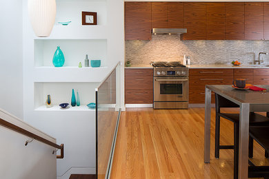 Inspiration for a contemporary single-wall eat-in kitchen remodel in San Francisco with an undermount sink, flat-panel cabinets, medium tone wood cabinets, quartz countertops, gray backsplash, mosaic tile backsplash and stainless steel appliances