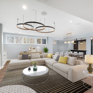 Inspiration for a large traditional look-out basement in Chicago with grey walls, laminate floors, brown floors and no fireplace.