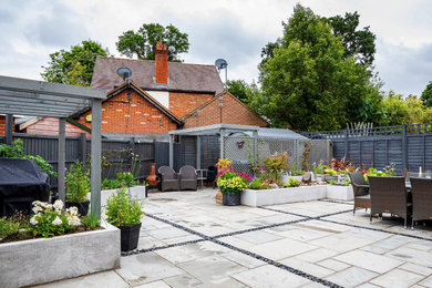 Inspiration for a mid-sized contemporary backyard partial sun garden for summer in Surrey with with raised garden bed and concrete pavers.