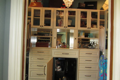 Inspiration for a mid-sized timeless gender-neutral walk-in closet remodel in Austin with raised-panel cabinets and white cabinets