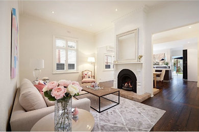 Inspiration for a mid-sized modern formal open concept living room in Melbourne with white walls, dark hardwood floors, a two-sided fireplace, a plaster fireplace surround and no tv.