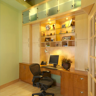 Inspiration for a contemporary home office in Minneapolis with green walls, medium hardwood floors and a built-in desk.