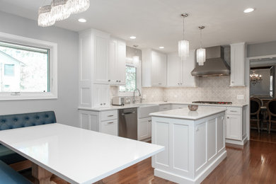 Eat-in kitchen - mid-sized transitional u-shaped dark wood floor and brown floor eat-in kitchen idea in Chicago with a farmhouse sink, shaker cabinets, white cabinets, quartz countertops, white backsplash, mosaic tile backsplash, stainless steel appliances, an island and white countertops