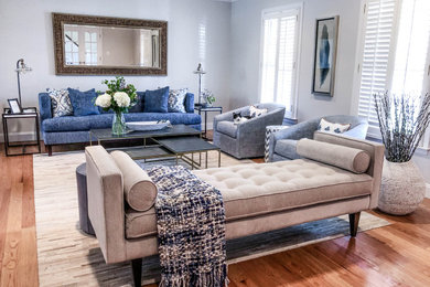 Inspiration for a transitional medium tone wood floor living room remodel with gray walls