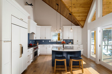 Inspiration for a mid-sized transitional l-shaped eat-in kitchen remodel in Burlington with shaker cabinets, white cabinets, quartz countertops and an island
