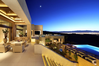 Huge contemporary beige two-story stucco exterior home idea in Las Vegas
