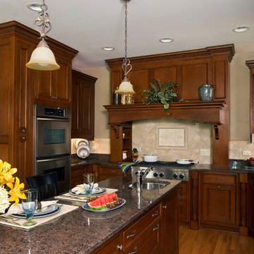 Cherry wood cabinet style range hood with built-in double ovens