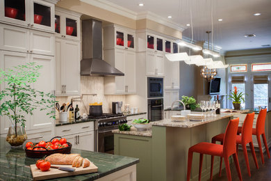 Example of a large transitional u-shaped medium tone wood floor open concept kitchen design in New York with an undermount sink, beaded inset cabinets, beige cabinets, granite countertops, beige backsplash, marble backsplash, stainless steel appliances and an island