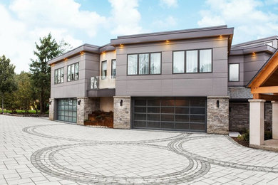 Garage - large contemporary four-car garage idea in Portland