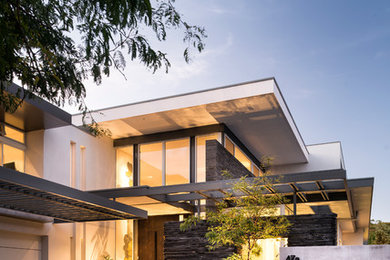 Contemporary two-storey white exterior in Perth with stone veneer and a flat roof.