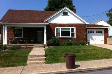 Example of a mid-sized cottage attached two-car carport design in Philadelphia