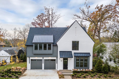 Large contemporary two-storey brick white house exterior in Detroit with a gable roof and a metal roof.