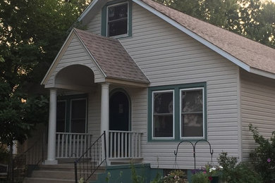 Beige two-story vinyl exterior home idea in Chicago
