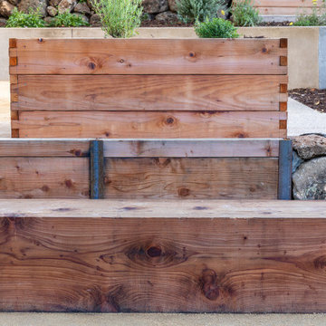 Wood timber benches, retaining wall, and raised bed