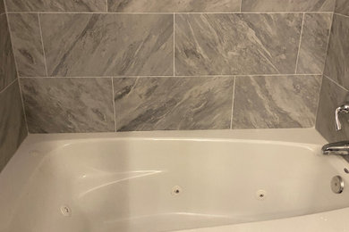 Example of a large minimalist master gray tile and ceramic tile single-sink drop-in bathtub design in DC Metro with flat-panel cabinets, a drop-in sink, granite countertops, gray countertops and a freestanding vanity