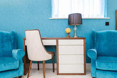 Large contemporary master bedroom in London with blue walls and carpet.