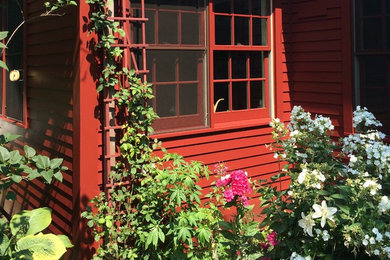 Mid-sized eclectic red two-story wood exterior home photo in Boston