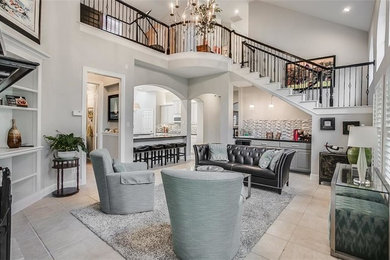 Example of a mid-sized open concept porcelain tile and gray floor family room design in Dallas with gray walls, no fireplace and no tv