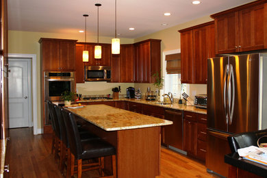 Mid-sized arts and crafts l-shaped light wood floor and brown floor eat-in kitchen photo in Bridgeport with an undermount sink, shaker cabinets, dark wood cabinets, granite countertops, multicolored backsplash, stone slab backsplash, stainless steel appliances and an island