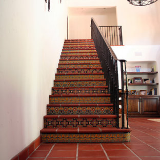 Inspiration for a mediterranean straight staircase in San Francisco with terracotta treads.
