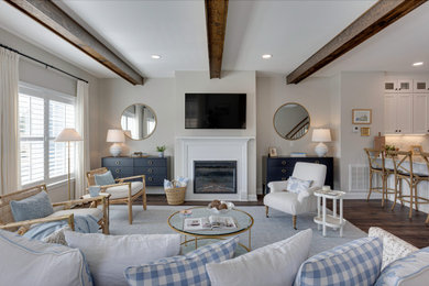 Inspiration for a cottage open concept dark wood floor, brown floor and exposed beam living room remodel in Richmond with beige walls, a standard fireplace and a wall-mounted tv